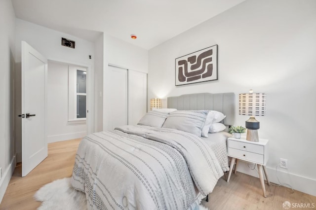 31 Romolo Pl Unit 1, San Francisco, CA 94133 - bedroom with light wood finished floors, a closet, and baseboards