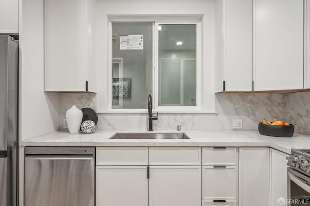 31 Romolo Pl Unit 1, San Francisco, CA 94133 - kitchen featuring a sink, white cabinetry, appliances with stainless steel finishes, and decorative backsplash
