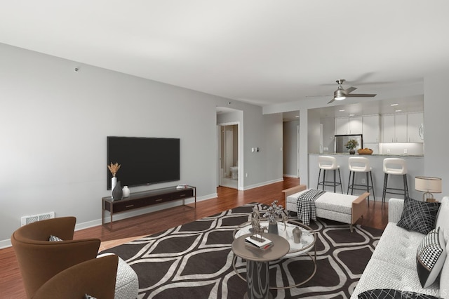 living room featuring hardwood / wood-style floors and ceiling fan