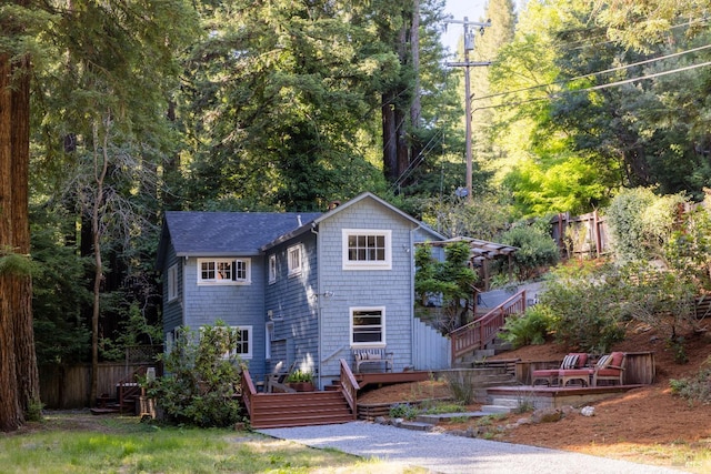2770 Bohemian Hwy, Occidental, CA 95465 - view of front facade with stairway, a wooden deck, and roof with shingles
