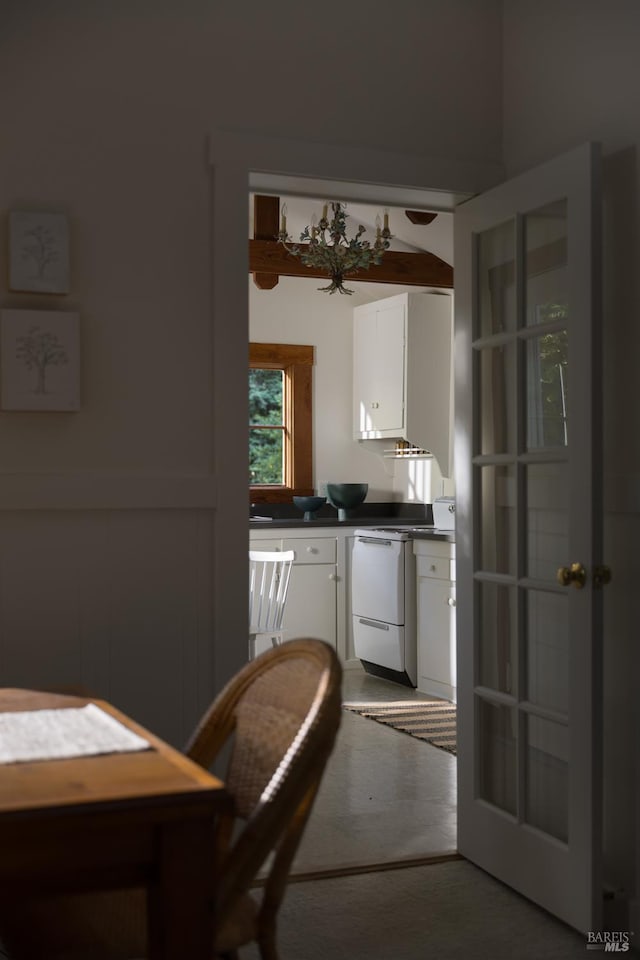 2770 Bohemian Hwy, Occidental, CA 95465 - kitchen featuring dark countertops, carpet floors, dishwashing machine, and white cabinets
