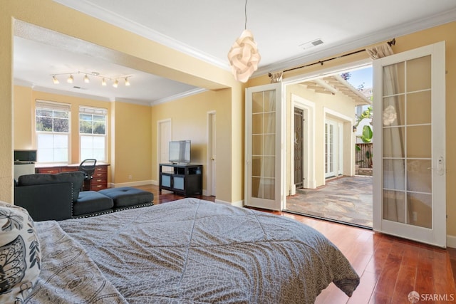 bedroom featuring dark hardwood / wood-style flooring, french doors, and ornamental molding