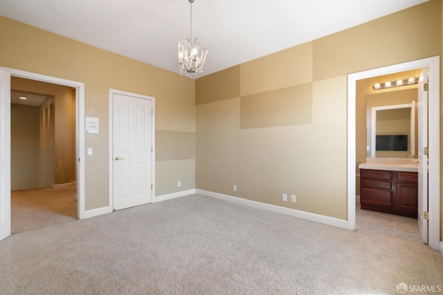 carpeted spare room featuring a chandelier