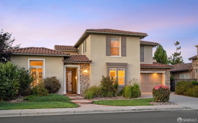 mediterranean / spanish house featuring a garage