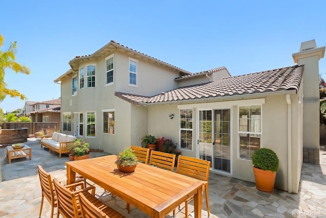 back of house featuring outdoor lounge area and a patio area