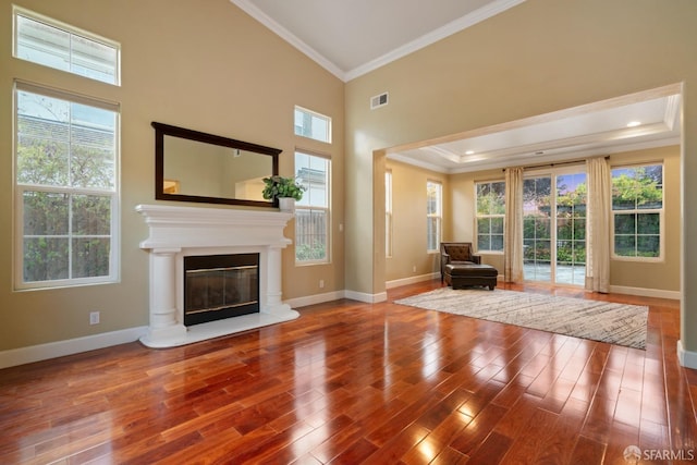 unfurnished living room with crown molding, hardwood / wood-style floors, and high vaulted ceiling