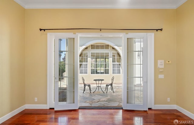 doorway to outside with hardwood / wood-style flooring and ornamental molding