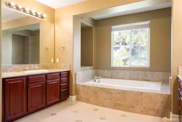 bathroom featuring tile patterned floors, vanity, and a relaxing tiled tub