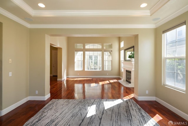 living room featuring dark hardwood / wood-style flooring, a tray ceiling, and ornamental molding