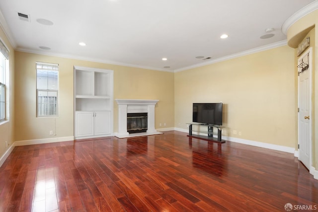 unfurnished living room with crown molding, built in features, and hardwood / wood-style flooring