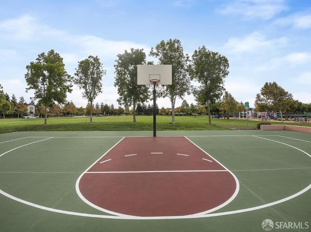 view of sport court featuring a playground and a lawn