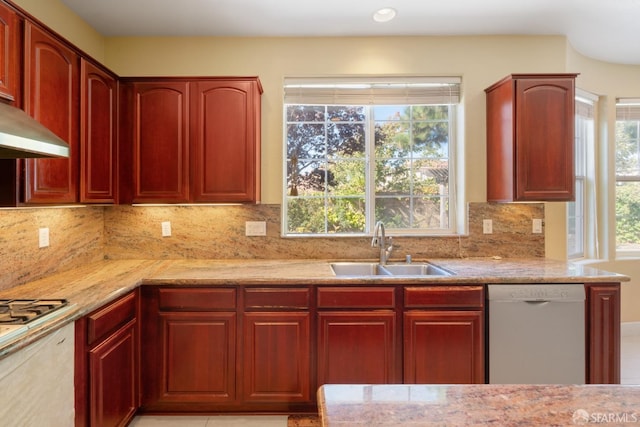 kitchen featuring decorative backsplash, appliances with stainless steel finishes, a wealth of natural light, and sink