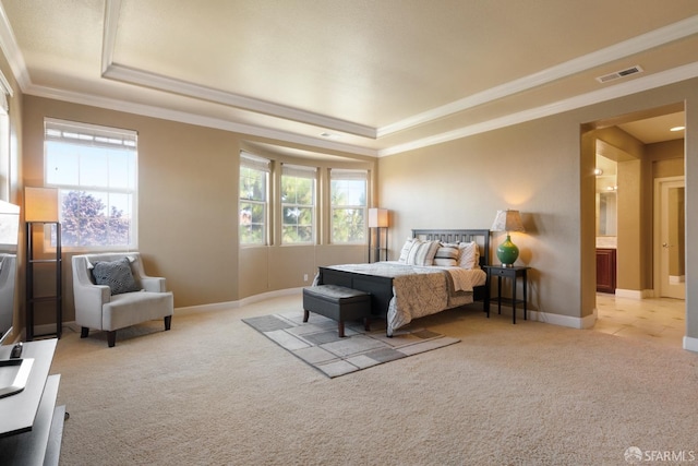 bedroom with light colored carpet, crown molding, and a tray ceiling