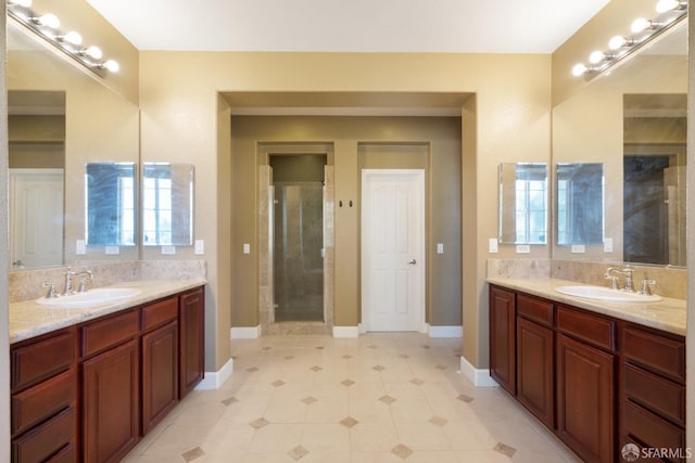 bathroom with a shower with door and vanity