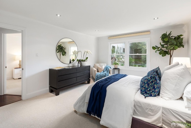 carpeted bedroom featuring baseboards, crown molding, and recessed lighting