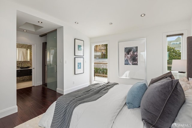 bedroom with baseboards, wood finished floors, and recessed lighting