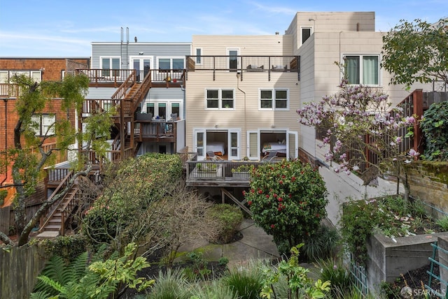 back of property featuring stairway