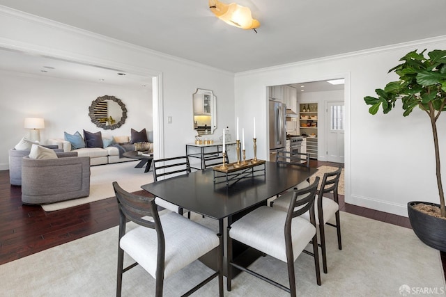 dining space with light wood finished floors, baseboards, and ornamental molding