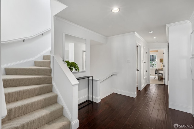 interior space featuring crown molding, baseboards, wood finished floors, and recessed lighting