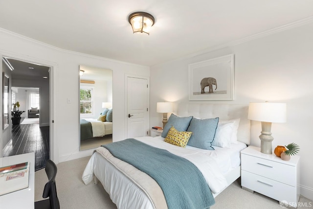 carpeted bedroom with baseboards and crown molding