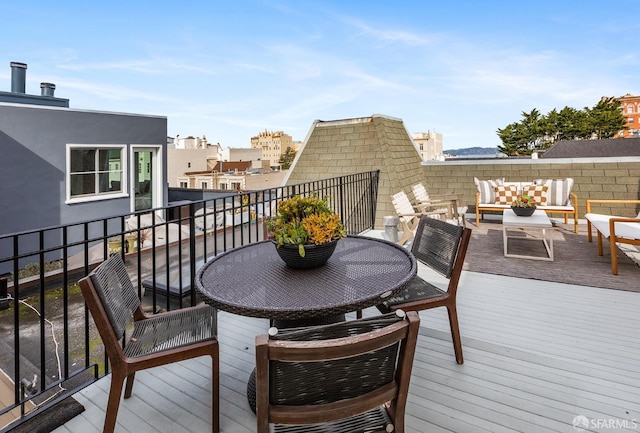 wooden terrace featuring outdoor lounge area