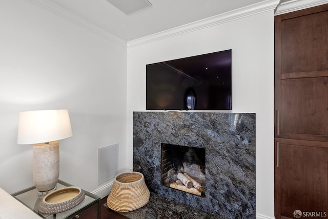 interior details featuring ornamental molding, a high end fireplace, and baseboards