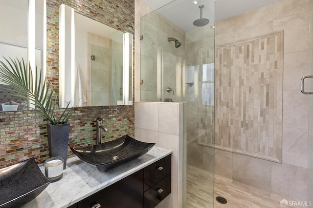 full bath featuring tasteful backsplash, a shower stall, and vanity