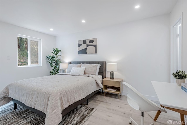 bedroom with recessed lighting, baseboards, and wood finished floors