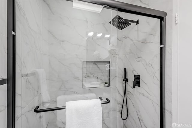 bathroom with a marble finish shower