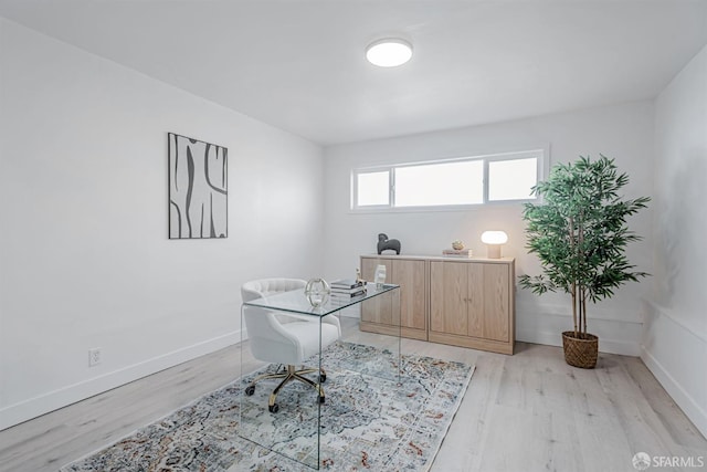 office space with light wood-style flooring and baseboards