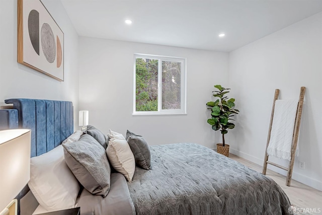 bedroom with recessed lighting, light wood-style flooring, and baseboards