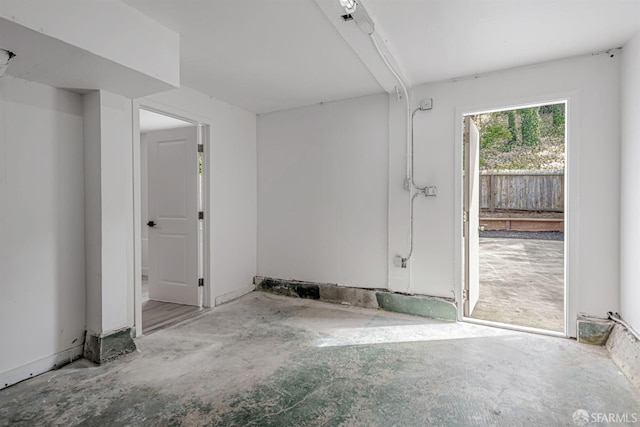 spare room featuring unfinished concrete flooring