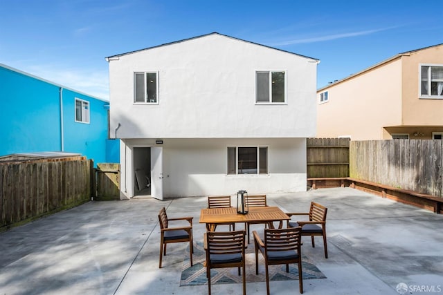 back of house featuring stucco siding, a fenced backyard, and a patio area