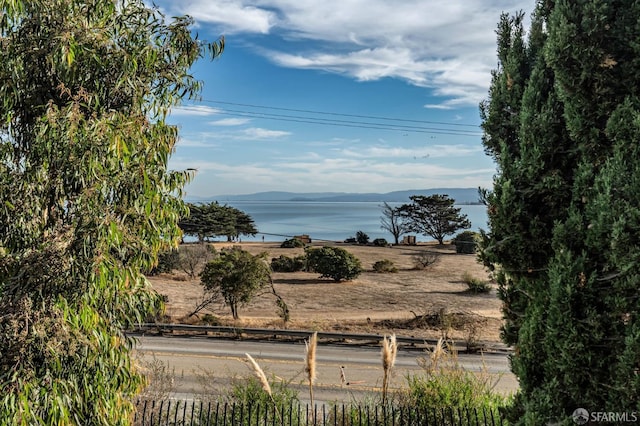 water view featuring a mountain view and fence