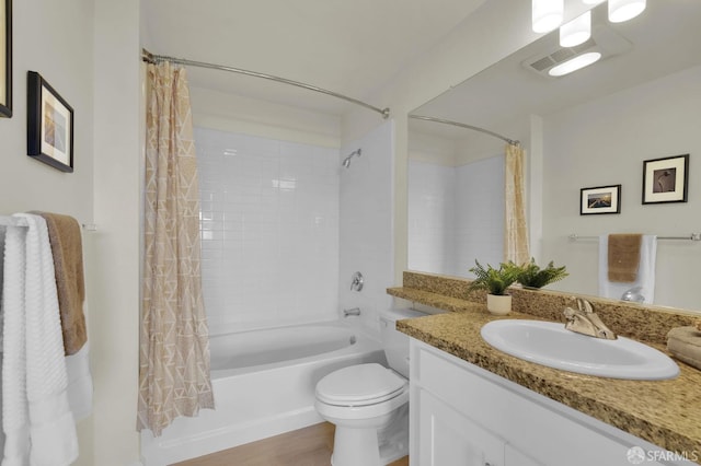 bathroom featuring vanity, toilet, and shower / tub combo with curtain