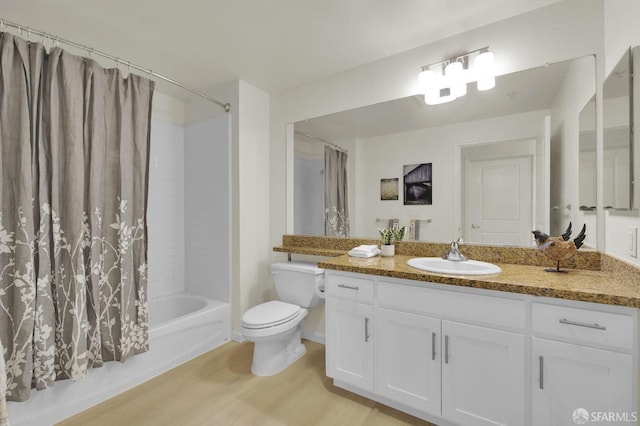 bathroom featuring vanity, toilet, wood finished floors, and shower / bath combo with shower curtain