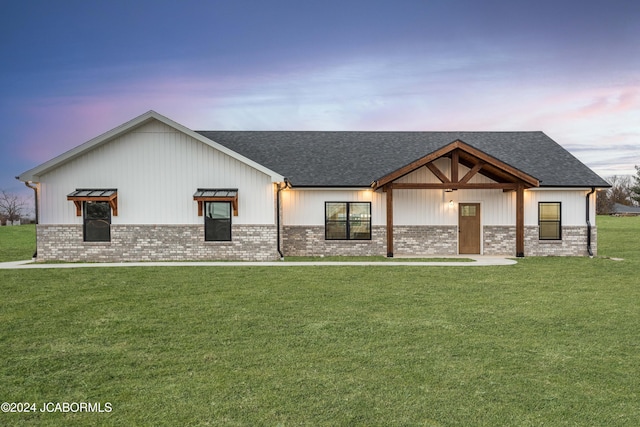 modern inspired farmhouse with a lawn