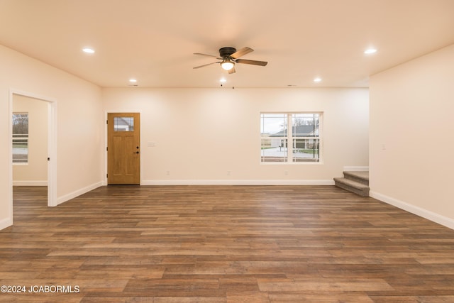 interior space featuring ceiling fan and dark wood-type flooring