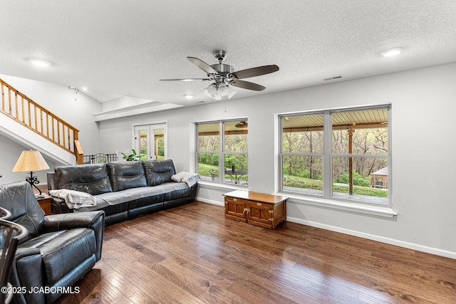 4750 E Soft Pit Hill Rd, Hartsburg, MO 65039 - living room with ceiling fan, dark wood-style flooring, healthy amount of natural light, a textured ceiling, and stairs