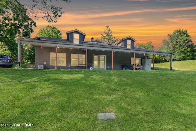 4750 E Soft Pit Hill Rd, Hartsburg, MO 65039 - rear view of house with french doors and a lawn