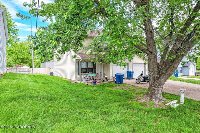 view of front of property featuring fence, a garage, concrete driveway, and a front yard