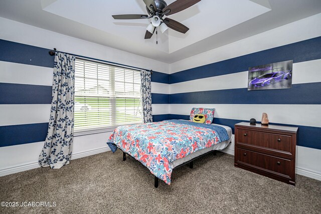 carpeted bedroom featuring baseboards and a ceiling fan