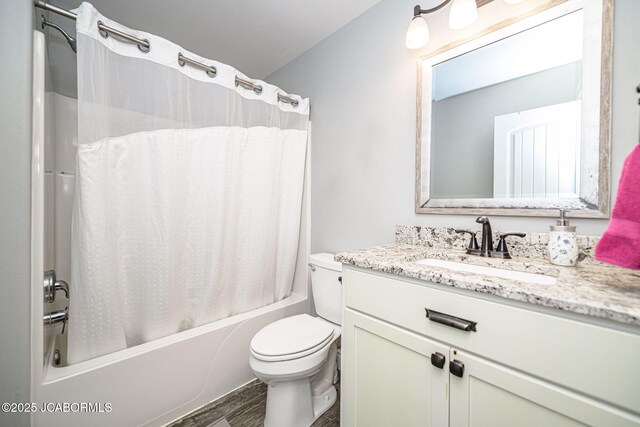 full bath featuring wood finished floors, shower / tub combo, toilet, and vanity