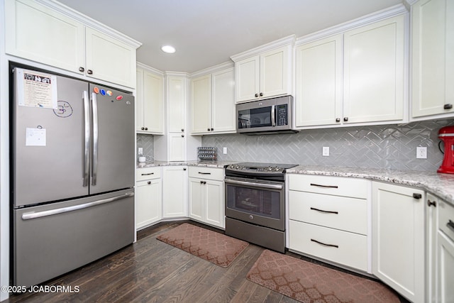 kitchen featuring appliances with stainless steel finishes, backsplash, dark wood-style flooring, light stone countertops, and recessed lighting