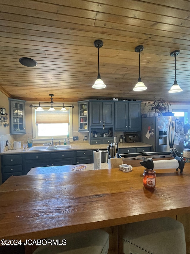 kitchen featuring blue cabinetry, sink, wood ceiling, and stainless steel refrigerator with ice dispenser