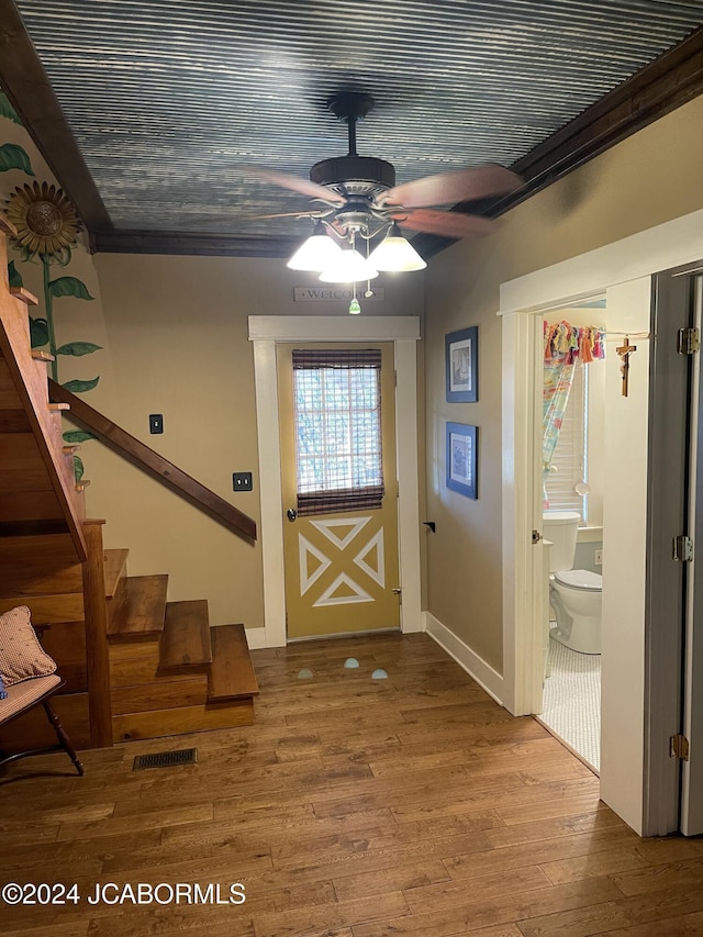 doorway to outside featuring hardwood / wood-style flooring, ceiling fan, and wood ceiling