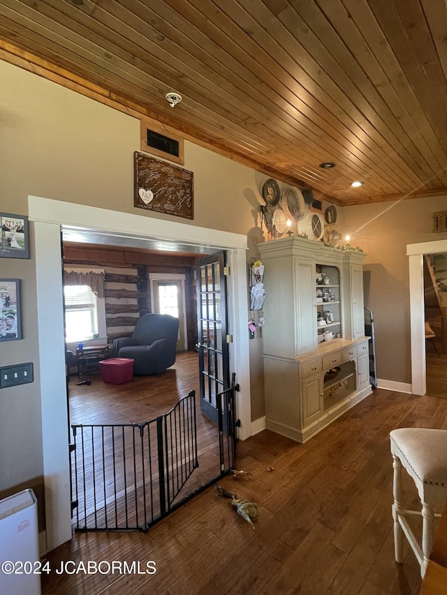 interior space with dark wood-type flooring and wood ceiling