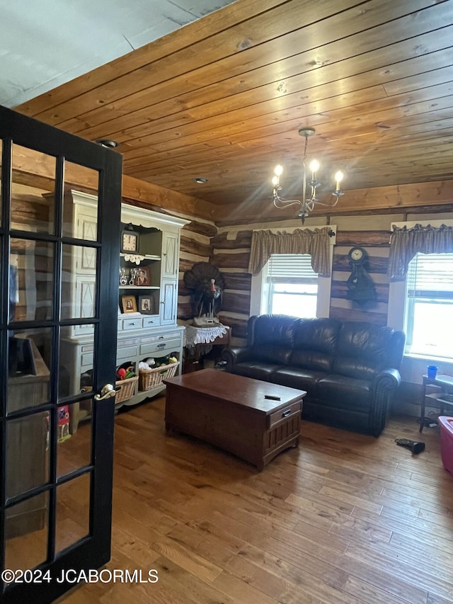 living room with wooden ceiling, wood-type flooring, rustic walls, and an inviting chandelier