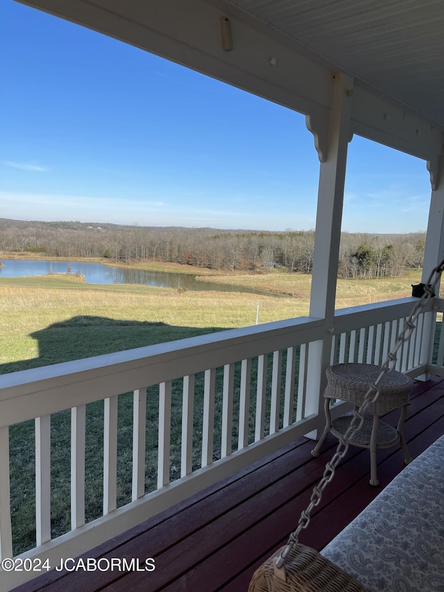 deck featuring a yard and a water view