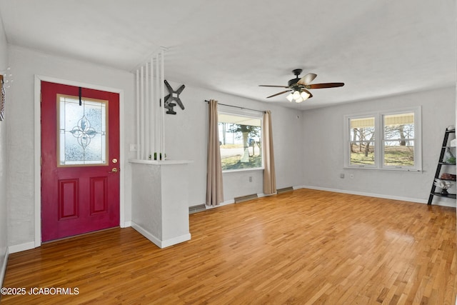 entryway featuring light wood-type flooring, baseboards, and a ceiling fan